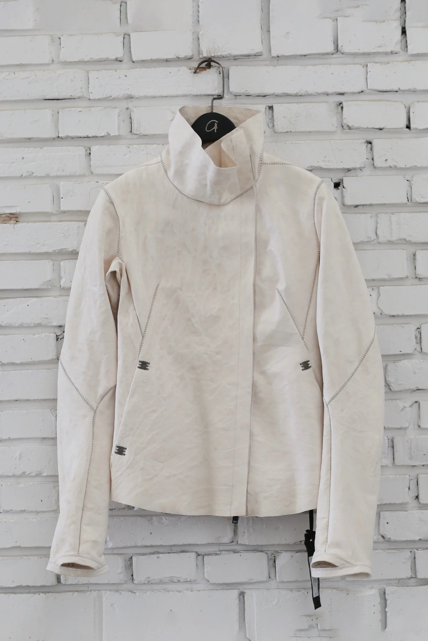 Isaac Sellam Fall/Winter 2025 High-Neck Asymmetrical Jacket, Two-Way Zipper, Lambskin, France. IS-PRUDENTE-CRASSE POU H26-PLATRE
